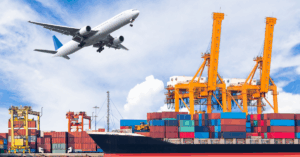 Airplane and cargo ships at a port with cranes in the background
